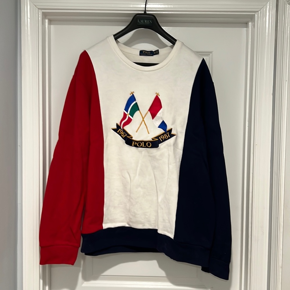 Red, white and blue crew neck sweatshirt with 1967 and 1987 flags. And hat